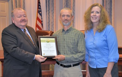 Jim and Patty Bourne of The Lambs Quarter accept the Sustainable Farmer of the Year Award from Commissioner Jerry Clark.