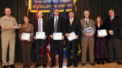 Vice Adm. Kevin McCoy, commander, Naval Sea Systems Command, presents the NAVSEA excellence award to six members of the NSWC Dahlgren Chemical, Biological and Radiological (CBR) Defense Division Operation Tomodachi Support Team at a Washington D.C. ceremony Dec. 7. Pictured left to right between Vice Adm. McCoy and NSWCDD CBR Defense Division Head Mike Purello: Jeanne Fravel-Meyers, Brian Liska, David Morad, Michael Pompeii, Richard "Chip" Warder and Julie Heflin (accepting the award for Paul Swayze, recently deceased). The 13-member team was honored for mitigating initial fleet concerns and ensuring military personnel could operate safely in a radiological contaminated environment in the wake of an earthquake and tsunami that disabled the Fukushima nuclear power plant's reactor cooling systems, leading to massive leaks of nuclear radiation.