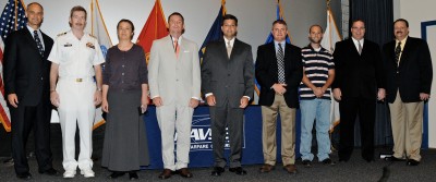 Six members of the Joint Program Office-Mine Resistant Ambush Protected (JPO-MRAP) Vehicle Program team are pictured at the Secretary of Defense Global War on Terrorism (GWOT) Medal ceremony held at Naval Surface Warfare Center Dahlgren Division (NSWCDD) July 27. NSWCDD Technical Director Carl Siel (far left), NSWCDD Commander Capt. Michael Smith, and Naval Sea Systems Command Executive Director Brian Persons (far right) honored 10 JPO-MRAP Vehicle Program team members in addition to 11 individuals at the event.