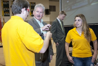 SMECO Senior Vice President of Engineering and Operations and Chief Operating Officer Kenneth M. Capps, center, spoke with members of the Robobees Robotics team about their college plans and career options prior to the start of the Southern Maryland VEX League Championship-Senior Division held at the College of Southern Maryland Feb. 16. “More and more, technology plays a significant role in electric utility operations. We look forward to a day when the skills students are learning in competitions like this robotics competition will be used at power plants and in substations, or used in the field to inspect and repair high voltage power lines,” Capps said. “Teamwork is such an essential part of (these competitions) and the teamwork is absolutely right on target when it comes to business as well.”