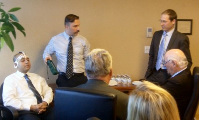 Employees at BrainScope in Bethesda demonstrate their concussion-assessment technology to U.S. Sen. Ben Cardin, D-Md., seated at far right. (Photo: Zack Ward)