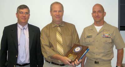 Michael Slocum - a Naval Surface Warfare Center Dahlgren Division (NSWCDD) engineer (middle) - receives the 2013 Dr. Robert J. Haislmaier Memorial Award for significant contributions in the field of electromagnetics directly impacting the fleet. He is pictured with NSWCDD Technical Director (left) Dennis McLaughlin and NSWCDD Commander Michael Durant after a recent award ceremony at Dahlgren.