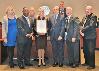 St. Mary’s County Administrator Dr. Rebecca Bridgett, center, is joined by St. Mary’s County Commissioners as she received her College of Southern Maryland associate’s degree in general studies from CSM President Dr. Brad Gottfried, to her right, and CSM Vice President and Dean of Leonardtown Campus Dr. Tracy Harris, to her left. Nearly 30 years after she transferred to Campbell University in N.C., Bridgett used the CSM reverse transfer program complete requirements for earning her associate’s degree. (Photo: St. Mary’s County Public Information Office)