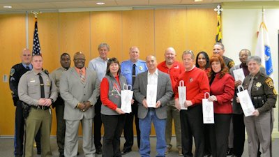 Photo: Front Row from left to right: Trooper Todd Newcomer; Guy Black; Ginny Crane; Nick Ferrante, Jr.; Larry Edwards; Pamela Smith; M/Cpl. Judith Thompson. Back Row from left to right: Cpl. Michael Payne; Sgt. Charles Simmons; Eric Best; Chief Carl Schinner; Wayne Magoon; Thomasina Coates; Sheriff Rex Coffey; William Young.