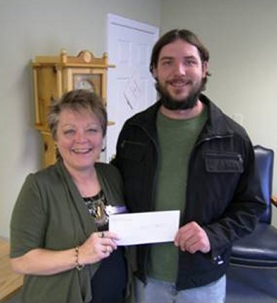 Brenda Laughhunn, Executive Director of Calvert Hospice accepts a donation from William Kreamer of Chesapeake’s Bounty.