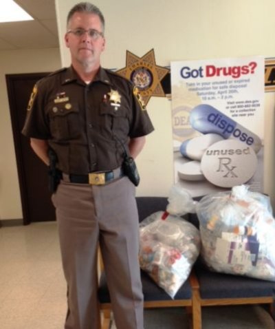 Lt. R. J. Williams, commander of the La Plata district, helps collect unused medications during national take-back medication day.