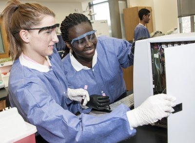 CSM medical laboratory technician program students Sunny Schemery of Leonardtown, left, and Diana Asumang of Waldorf work with a complete blood count (CBC) analyzer to test a specimen sample during a lab class at the La Plata Campus. (Submitted photo)