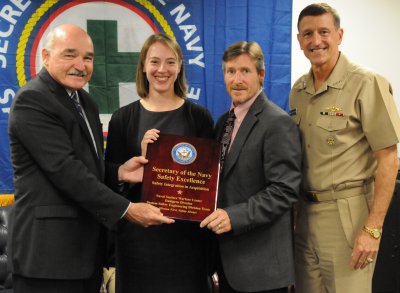 Assistant Secretary of the Navy (Energy, Installation and Environment) Dennis McGinn presents the Secretary of the Navy Safety Excellence Award to Navy systems safety experts Rebecca Funkhouser and Robert Heflin as Commander, Naval Sea Systems Command (NAVSEA) Vice Adm. William Hilarides looks on during a Pentagon ceremony Oct. 20. Heflin and Funkhouser accepted the award on behalf of their Naval Surface Warfare Center Dahlgren Division Systems Safety Engineering Division colleagues who are dedicated to providing Sailors with the safest possible environment in addition to developing new and innovative approaches to system safety engineering for systems of systems and new and emergent technologies.