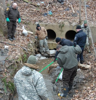 Detectives search a creek bed for remains of Crystal Keyona Anderson after a hiker discovered a boot with a bone inside and alerted them. (Photo: CCSO)