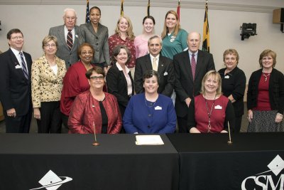 Participating in the signing ceremony for the Agreesent for Dual Admission between UMSON and CSM April 8 in La Plata were, first row seated from left, UMSON Assistant Dean for Baccalaureate Program Dr. Janice Hoffman, CSM Health Sciences Division Chair Dr. Laura Polk and CSM Associate Professor/Nursing Program Area Coordinator Dr. Karen Russell; second row from left, CSM Trustee Chair Michael L. Middleton, University of Maryland Medical Systems and University of Maryland Charles Regional Medical Center Board Member Sara Middleton, CSM Trustee Dr. Janice Walthour, UMSON Dean Dr. Jane Kirschling, CSM President Dr. Brad Gottfried, University of Maryland, Baltimore Senior Vice President and Dean of Graduate School Dr. Bruce Jarrell, CSM Assistant Professor/Clinical Simulation Coordinator Linda Goodman and CSM Nursing Professor Rocin Young; third row from left, CSM Trustee Dr. John Roache, UMSON Director of Admissions Marchelle Payne-Gassaway and CSM third-sesester nursing students Valerie Dowell, Lindsey Acquaviva and Suzanne Hamsett.