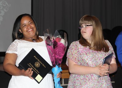 Adult Independence Program (AIP) graduates Khrystan Green, left, and Candice Wedding, right, walked off the North Point High School auditorium stage with diplomas in hand at a graduation ceremony held May 15.