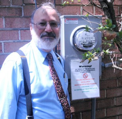 Jonathan Libber stands next to his analog electricity meter at his home in Baltimore in April 2015. (Photo: Nate Rabner)