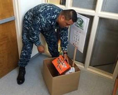 Yeoman 1st Class Rollis Talalemotu donates food to Feds Feed Families. Feds Feed Families is a program through the U.S. Department of Agriculture that provides a venue for federal employees to donate non-perishable foods that are distributed throughout their local communities. (U.S. Navy photo by Shawn Graham)