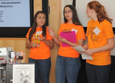 Jessica Salinas, Marlene McGraw, and Anna Slominski - high school students mentored by Naval Surface Warfare Center Dahlgren Division (NSWCDD) scientists and engineers - brief unmanned systems experts on "Integrating Autonomous Systems in the Pre-College Environment using FIRST Robotics" at the second annual NSWCDD Unmanned Systems Integration Workshop and Technical Exchange Meeting, Aug. 19. They were among students from two robotics teams who provided hands-on robotics demonstrations throughout the day. FIRST (For Inspiration and Recognition of Science and Technology) is a non-profit organization with the mission to design accessible, innovative programs to build self-confidence, knowledge and life skills while motivating young people to pursue opportunities in science, technology and engineering. (U.S. Navy photo by Tammy Indseth/Released)