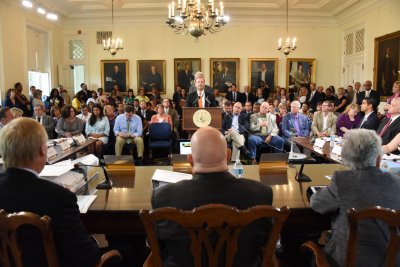 Public Safety Secretary Stephen Moyer at podium testifies Wednesday to the Board of Public Works, foreground from left, Comptroller Peter Franchot, Gov. Larry Hogan, Treasurer Nancy Kopp. (Photo: Governor's Office)