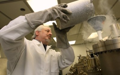 DAHLGREN, Va. - Naval Surface Warfare Center Dahlgren Division (NSWCDD) scientist Dr. Kevin Boulais uses liquid nitrogen in a molecular beam epitaxy system to create photocapacitors for light guide film applications. Boulais was one of three NSWCDD inventors presenting their patented and patent pending innovations before a panel of university professors, business owners and entrepreneurs at the ninth Office of Naval Research-sponsored Innovation Discovery event, Aug. 20, 2015. The program - identified as a best practice by the Navy Technology Transfer Program - enables NSWCDD to exploit the government's intellectual property generated during the research and development process. The patents' technical transfer can result in royalty income for the Navy. If commercial product sales are made that include these patents in the future, a percentage of those sales will also come back to the inventors and NSWCDD in the form of royalties. U.S. Navy photo by Master Chief Mass Communication Specialist D. Kevin Elliott (Released)