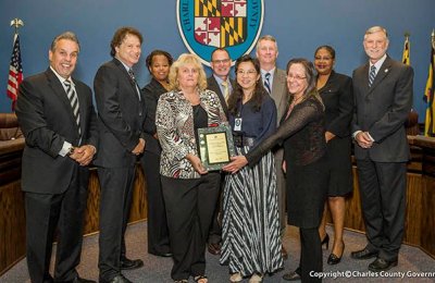 Pictured, left to right: Commissioner Bobby Rucci (District 4); Commissioner Vice President Ken Robinson (District 2); Commissioner Amanda M. Stewart, M.Ed. (District 3); Lisa Wood, Department of Fiscal and Administrative Services; David Eicholtz, Department of Fiscal and Administrative Services; Holly Sun, GFOA; William DeAtley and Jacqueline Garland, Department of Fiscal and Administrative Services; Commissioner Debra M. Davis, Esq. (District 2); and Commissioner President Peter F. Murphy.