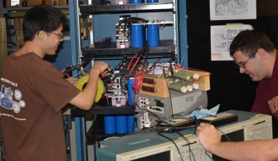 Students assemble components of Virginia Tech's electromagnetic railgun pulse forming network at the university's Energy Conversion Systems Laboratory. Naval Surface Warfare Center Dahlgren Division (NSWCDD) railgun experts have been advising Virginia Tech students and professors since 2011. "The experience the student gains at Virginia Tech working on relevant railgun work is directly applicable to the skill sets we need to transition this technology into a reality for the Navy," said Chris Reichart, NSWCDD Pulsed Power Branch head.