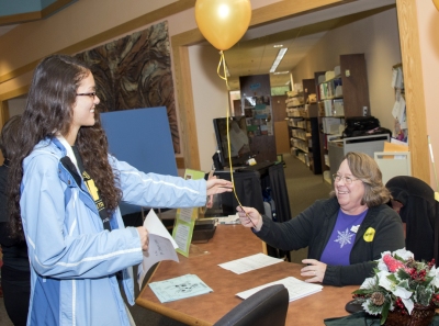 Throughout #GivingTuesday, scholarship recipients at the College of Southern Maryland made phone calls and delivered balloon bouquets to thank those who donated funds totaling $36,424 to CSM during the 24-hour online giving day. Delivering a thank you is CSM student Emily Smith, left, to CSM Senior Circulation Manager Anita Warnes. (Photo: CSM)