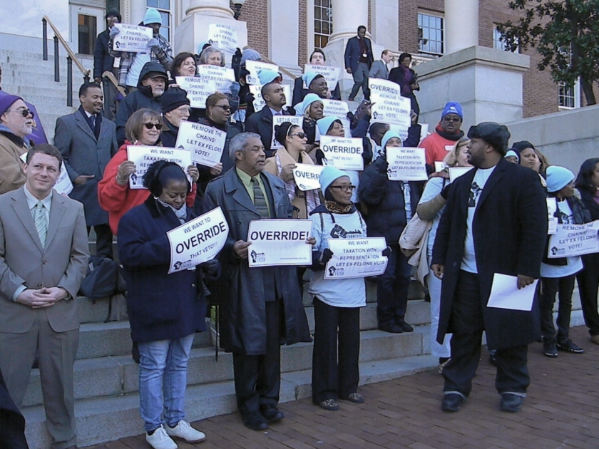 John P. Comer, lead organizer of Maryland Community United, led chants of "override! override!" and "shame! shame!" on the steps of the State House Thursday, regarding Gov. Larry Hogan's veto of legislation last spring that would permit ex-felons to vote. (Photo: Josh Magness)