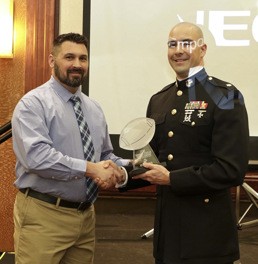 Rick Sneade, the head football coach for Calvert High School, on left, and U.S. Marine Corps Maj. Jason C. Copeland, the commanding officer of Marine Corps Recruiting Station Baltimore. (U.S. Marine Corps photo by Sgt. Bryan Nygaard/Released)