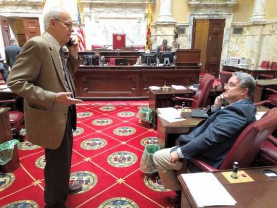 Sen. Paul Pinsky, left, and Sen. Richard Madaleno, floor leader of the College Affordability Act, Sen. Bill Ferguson put the photo on his Facebook page with the comment: "Want to know what legislating is like? This picture captures it. Two legislators on the floor, each on the phone trying to negotiate a compromise amendment to an important college affordability bill to help Marylanders."