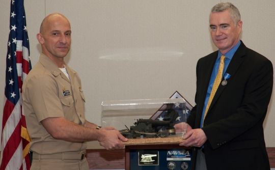 DAHLGREN, Va. - Naval Surface Warfare Center Dahlgren Division (NSWCDD) Commanding Officer Capt. Brian Durant presents the Dahlgren Award to NSWCDD Deputy Technical Director Dohn Burnett for 34 years of continuous service in March 2016. Burnett - who was also awarded the Navy Superior Civilian Service Medal at his retirement ceremony - considers leadership development as one of the top highlights of his civil service career. "Their (NSWCDD leaders at all levels) work is going to continue after the systems I helped develop are gone," said Burnett. "I made it a priority in my career to work on developing leaders and, in turn, they will develop leaders. That legacy will live on and Dahlgren will continue to do great work because it has good leaders."