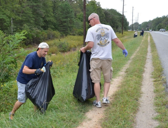Volunteers from the NAS Patuxent River CPO Association collecting bags of trash from a stretch of Three Notch Road in Sept. 2015. (U.S. Navy photo by Donna Cipolloni)