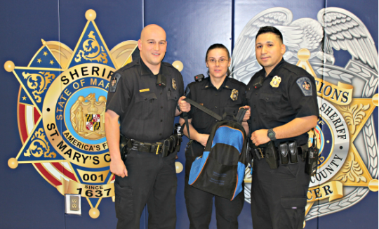 (L-R Deputy Patrick Britt, Lt. Christa Morzes-Cook, and CFC Roberto Ramos-Blanco, hold a 'Welcome Home' Re-entry Program backpack. The backpacks are given to homeless inmates leaving the Detention Center, as part of the Re-Entry Program. (Photo: SMCSO)