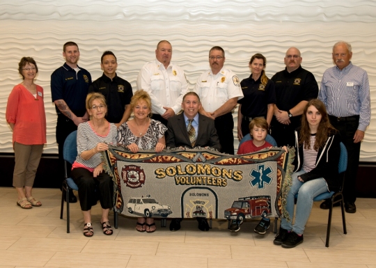 Pictured (l to r) seated are Mr. Lankford's daughters Betty Norris and Charlene Lankford, Commissioner Mike Hart, Zachary Hart and Lexi Hart. Back row (l to r) Sherrod Sturrock, Acting CMM Director, Solomons VRSFD crew Britton Williams, Devin Edwards, President John Pardoe, Chief Joe Ford, Alison Dickson, Joey Leannarda and Richard Dodds, Curator of Maritime History. (CMM photo courtesy Robert Hall)