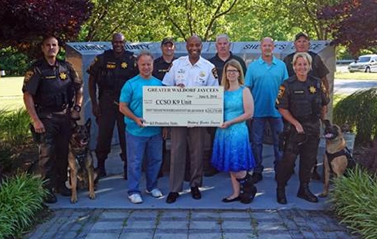 From left to right: PFC Claude Clevenger and K9 Eno, PFC Byron Clark, Mr. Kevin Wedding, SGT Haven Smith, Sheriff Troy Berry, K9 Trainer Billy Cotton, Ms. Leesa Langley, Mr. Vince Houchin, CPL Sean Brown, and CPL Renee Cuyler and K9 Cooper.