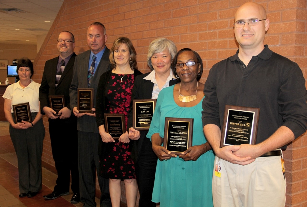 The Charles County Board of Education honored outstanding support staff members at its June 14 meeting. Pictured are Jill Sprouse, food service manager at T.C. Martin Elementary School was named the outstanding food service employee, left; student data accounting specialist George Simms was named the outstanding central office employee; carpenter George "Ted" Estevez was named the outstanding maintenance employee; secretary to the principal of C. Paul Barnhart Elementary School Susan Pond was named the outstanding secretary; Juin Lai, media instructional assistant at Henry E. Lackey was named the outstanding instructional support employee; Veistella Milstead, assistant building service worker and night manager at Milton M. Somers Middle School was named the outstanding building service employee; and Trevor Gillum, a computer analyst, was named the outstanding information technology employee.