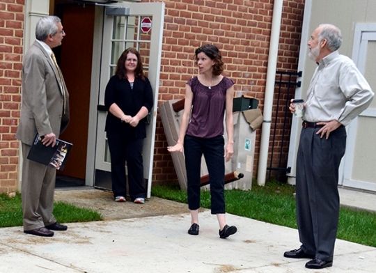 During an early-morning tour of the St. Charles Children's Learning Center at the College of Southern Maryland, Maryland Secretary of Health and Mental Hygiene Van T. Mitchell, right, viewed the center's newest addition, a trike path that's ideal for children to ride tricycles and other wheeled toys. Auxiliary Services Executive Director Marcy Gannon, second from left, and Operations Manager Andrea Muntz, center, described to Mitchell and CSM President Dr. Brad Gottfried, left, how the paved trike path provides the opportunity for the children to safely ride toys every day.