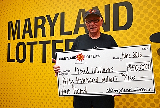 Shady Side resident David Williams with his ceremonial $50,000 lottery prize check.