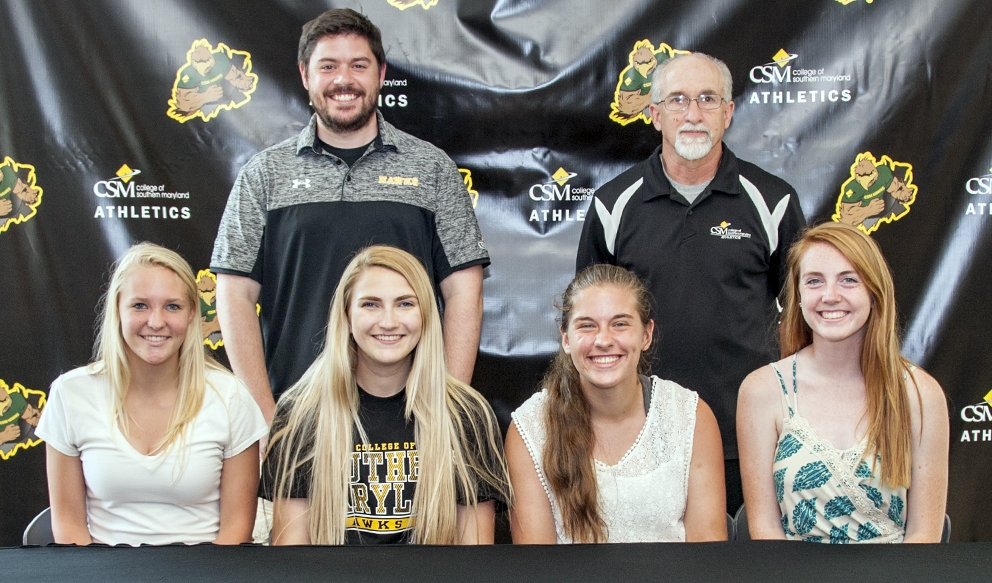 CSM Head Coach Barry McGrellis, left, and Assistant Coach Paul Tarry, right, join four players signed to the 2016 Women's Soccer team, including, seated from left, Elizabeth Schwenk of Owings, Rebecca Ladner of California, Jazmin Summers of Mechanicsville and Brenna Kelly of Leonardtown.