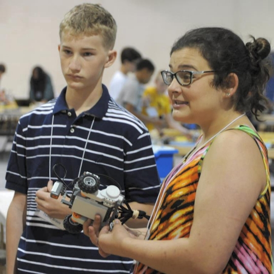 Madeline -- a rising Spotsylvania High School freshman -- mentors middle school students with another junior mentor at the 2016 Naval Surface Warfare Center Dahlgren Division (NSWCDD)-sponsored Navy science, technology, engineering, and mathematics (STEM) Summer Academy, held June 27 to July 1. Last year, while a student at the event, Madeline became inspired about STEM. This year, she was one of nine junior mentors who worked with teachers and senior mentors to advise the campers and brief parents during tours. (U.S. Navy photo by Patrick Dunn/Released)