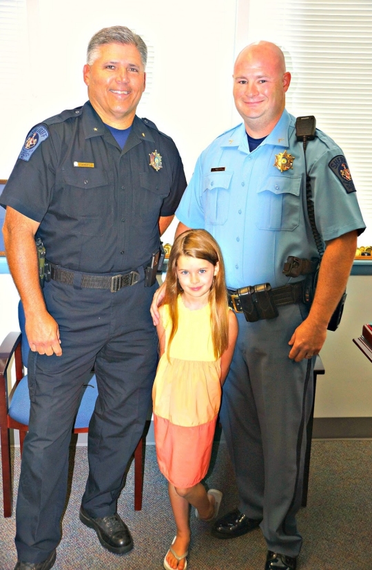 (L-R) Sheriff Tim Cameron, Deputy James Maguire, and Carlie Maguire during Deputy Maguire's swearing-in on August 2, 2016, at Sheriff's Office Headquarters.