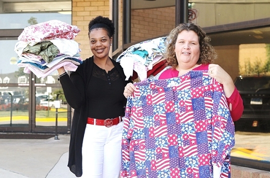 Emergency Department (ED) nurse Cathy Ruffin and ED secretary Tita Ball display some of the items sent to help flood-stricken Louisiana hospitals. (Photo courtesy MedStar)