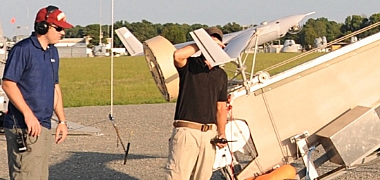 DAHLGREN, Va.—Navy engineers Jonathan Elliott and Richard Lay conduct pre-launch check-outs of a Scan Eagle unmanned aerial vehicle (UAV) at the Naval Surface Warfare Center Dahlgren Division Potomac River Test Range, Aug. 30. The Scan Eagle was crucial to the Navy's evaluation of a strike group's gun weapon systems, combat systems, and unmanned vehicles integrated with surface and air assets at the 2016 USS Dahlgren demonstration.