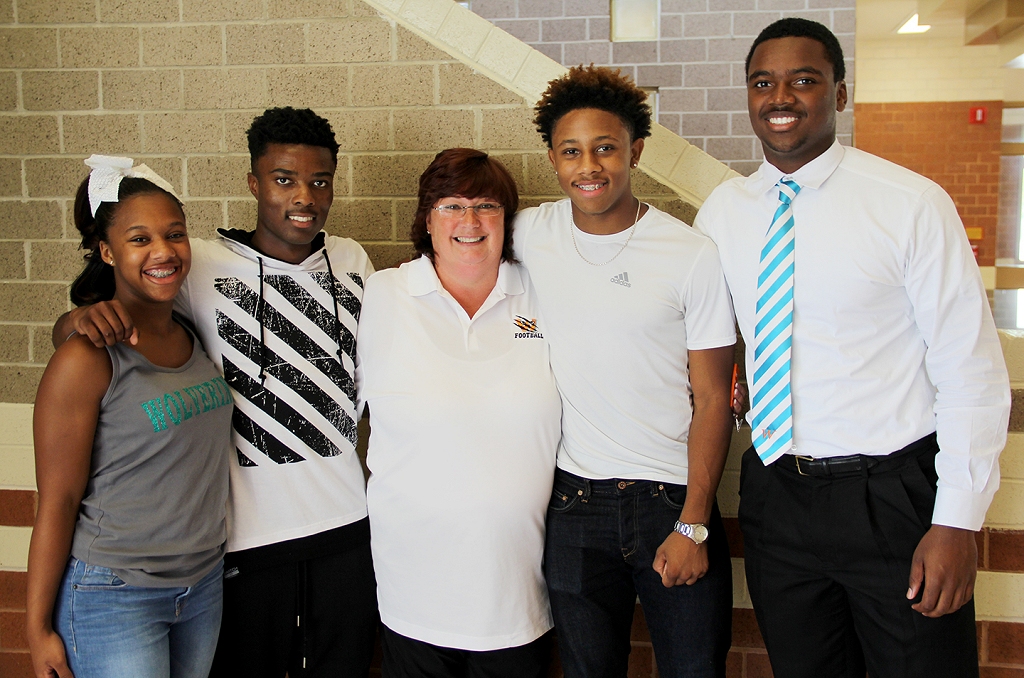 Westlake High School track and field coach Elisabeth "Beth" Shook, pictured second from left, was recently honored by the U.S. Track & Field and Cross Country Coaches Association as the 2016 Maryland Boys' Coach of the Year. Shook credits her student athletes with the recognition and is well respected among the Westlake community. Pictured with Shook, from left, are a few of the students she coaches – junior Talore Forrest and seniors Will Moten, Thomas Alcorn and Pearson Benson.