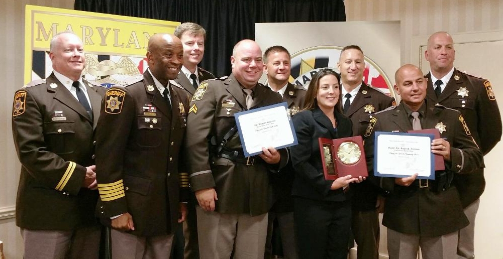 From L to R, front row: Major David Saunders, Sheriff Troy Berry, Cpl. Kristian Syvertsen, Detective Patricia Adams, and Master Corporal Roger Calloway. Back row: Captain Stephen Salvas, Major Christopher Becker, Captain Michael Almassy, and Lieutenant Joseph Pratta.