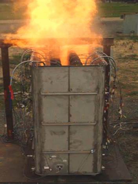 DAHLGREN, Va. - A Longbow Hellfire Missile rocket motor burns while being restrained within the container during a recent test of the missile exhaust containment structure at Naval Surface Warfare Center Dahlgren Division's (NSWCDD) Explosive Experimental Area. NSWCDD engineers successfully completed the restrained firing test of the Longbow Hellfire missile for the Littoral Combat Ship Surface-to-Surface Missile Module, the Navy announced, Oct. 6. "This critical test concludes another vital step in a series of efforts that will lead to the fielding of this tremendous capability to LCS and to the Fleet," said Capt. Ted Zobel, program manager for the LCS Mission Module Program. (U.S. Navy photo/Released)