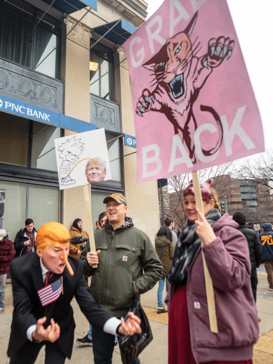 Dr. Gil Mobley, a doctor and medical-marijuana activist (left), dons a pinocchio Donald Trump mask in Dupont Circle at the DCMJ #TRUMP 420 event on Friday, Jan. 20, 2017. (Photo: Tom Hausman)