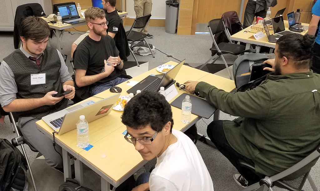 The CSM Cyberhawks compete at the Maryland Community College Cyber Competition held April 7 at the Montgomery Community College Germantown Campus, including, far left then clockwise around the table, team members Cody Hight, Caleb Craft and Don Price, sitting with CSM club member James Graves, who did not compete. (Photo: CSM)