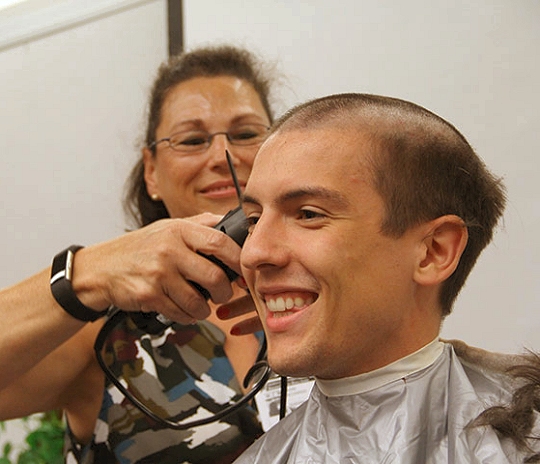  Diane Richards, left, shaves teacher Daniel Di C occo’s head. Stoddert's  Builder’s Club raised more than $4,000 for Relay for Life Charles County. The goal reached meant Di Co cco and sixth-grade teacher Holly  Walsh would shave their head in front of students who donated to the fundraiser.