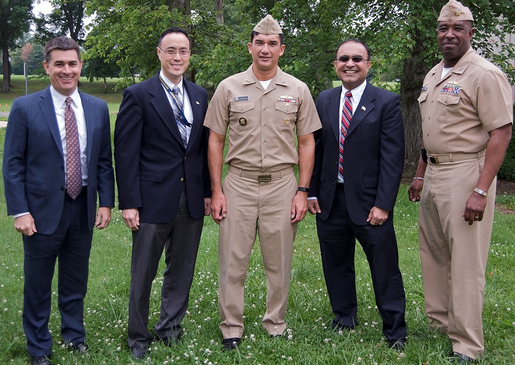 Rear Adm. Patrick Piercey, Naval Surface Force Atlantic commander, center, is pictured with Naval Surface Warfare Center Dahlgren Division (NSWCDD) leadership at the command's Asian American and Pacific Islander Heritage Month Observance. After his keynote speech, Piercey received technical briefings during a tour of NSWCDD facilities and laboratories dedicated to directed energy, surface warfare, and cybersecurity research, development, test and evaluation. Standing left to right: Dale Sisson, NSWCDD deputy technical director; Jim Yee, NSWCDD deputy department head for gun and electric weapon systems; Piercey; Gaurang Dävé, NSWCDD senior cyber technical advisor; and Capt. Gus Weekes, NSWCDD commanding officer. (U.S. Navy Photo by Patrick Dunn/Released)