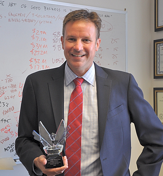 Kris Parker, Naval Surface Warfare Center Dahlgren Division (NSWCDD) deputy for small business, is inspired by a quote -- written on his whiteboard in the background -- spoken by Sir Michael Gambon in Matthew Vaughn's Layer Cake: "The art of good business is being a good middleman". Parker is holding the Department of the Navy Office of Small Business Program Award for NSWCDD's first-time achievement of a statutory small business goal -- three percent of total contracted dollars to service disabled veteran owned small businesses.

DON Office of Small Business Programs, small business, Naval Surface Warfare Center Dahlgren Division, NSWCDD, Service Disabled Veteran Owned Small Business Contracts, Disabled Veterans, Veteran Owned Small Business, Statutory Goal Achievement Award, Statutory Goal