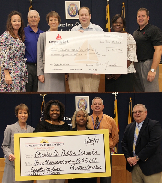 Top: Community Bank of the Chesapeake employees held a summer fundraiser to benefit Charles County Public Schools. Bank representatives recently presented a check for $1,800 to CCPS. Pictured from left are Diane Hicks, vice president and director of marketing for Community Bank of the Chesapeake, Greg Cockerham, the bank’s executive vice president and chief lending officer, Charles County Public Schools Superintendent Kimberly Hill, Bill Pasenelli, chief executive office with Community Bank of the Chesapeake, Teresa Roach, vice president and Charles County market manager and Patrick Pierce, senior vice president and senior lender with the bank.

Bottom: Representatives of the Community Foundation of Southern Maryland presented a check on behalf of an anonymous donor to Charles County Public Schools. A donation of $5,000 was made to benefit students in the areas of athletics and the arts. Pictured from left is Superintendent of Schools Kimberly Hill, Christine Shelton, board member of the Community Foundation, Ellen Flowers Fields, the foundation's board chairwoman, Tim Bodamer, CCPS content specialist for fine and performing arts, and Steve Lee, coordinator of student activities.