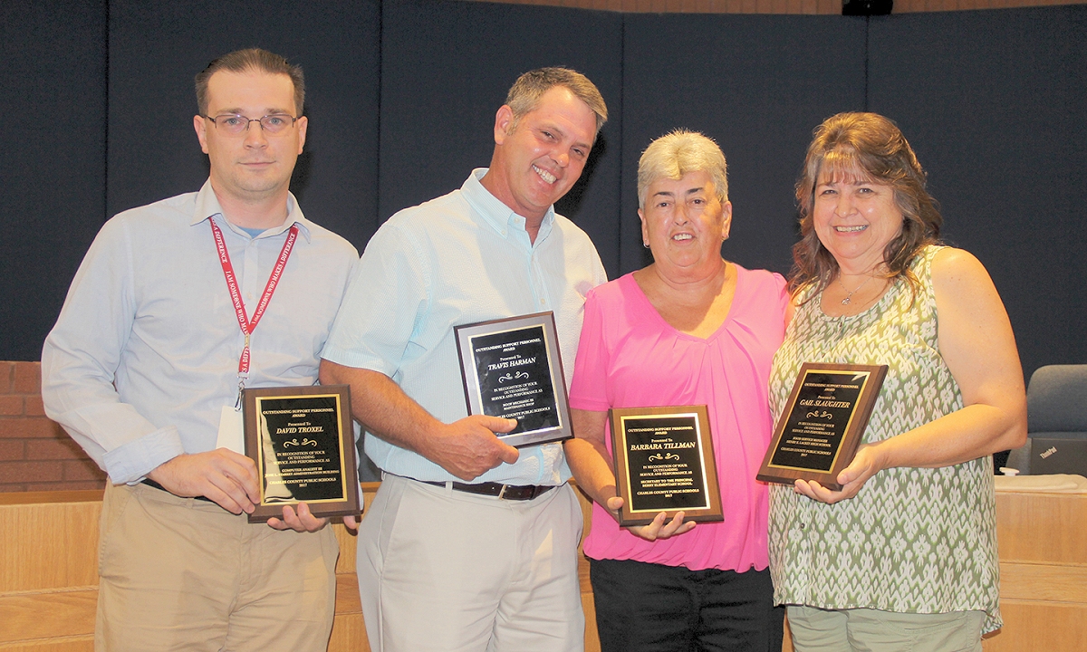 The Board of Education at its June 13 meeting honored four Charles County Public Schools exemplary employees with support staff awards to recognize their contributions to the school system. Honored, from left, was David Troxel, a computer analyst at St. Charles High School with the Outstanding Information Technology Employee award, Travis Harman, a roof mechanic based out of the Charles County Public Schools Maintenance Shop, with the Outstanding Maintenance Employee award, Barbara Tillman, principal’s secretary at Berry Elementary School, with the Outstanding Secretary award, and Gail Slaughter, the food service and nutrition manager at Henry E. Lackey High School, with the Outstanding Food Service Employee award. Jacqueline Douglas, a kindergarten instructional assistant at Dr. James Craik Elementary School, was also honored with the Outstanding Instructional Assistant award but was unable to attend the recognition ceremony.