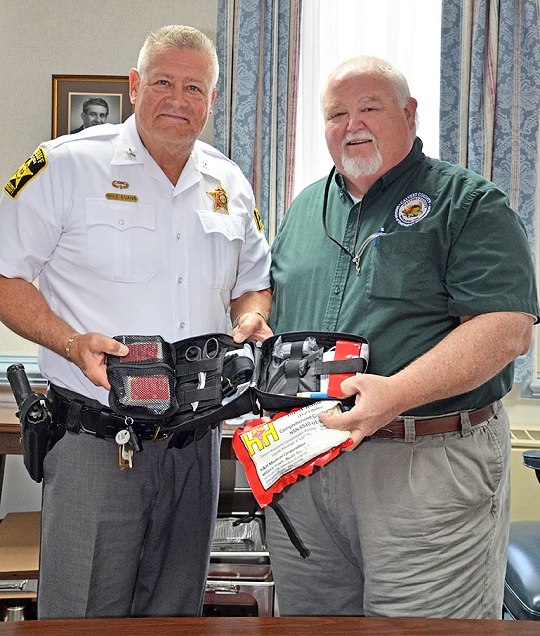 Sheriff Mike Evans and Emergency Management Division Chief Al Jeffery display one of the new Individual First Aid Kits.